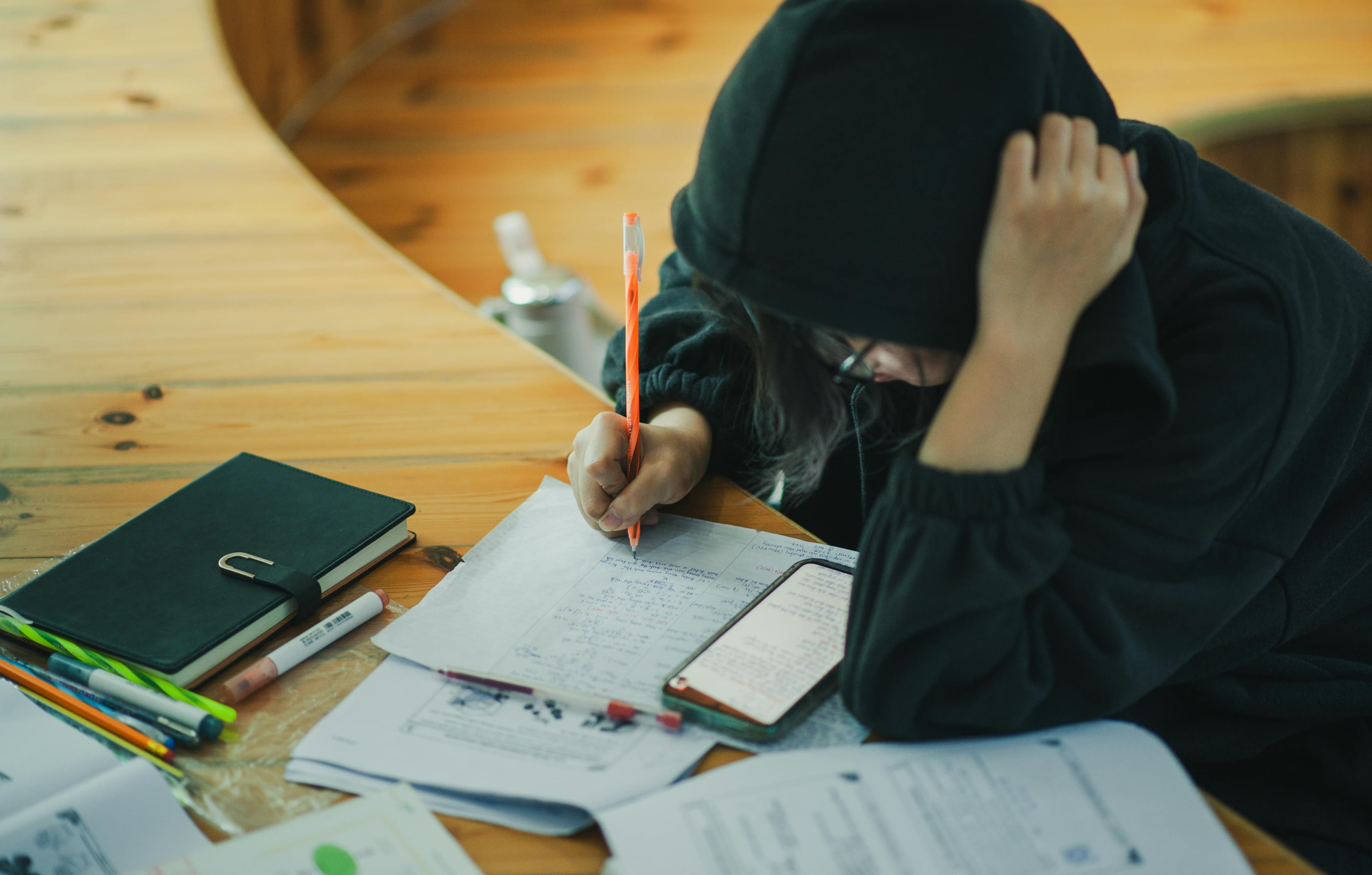 Student writing in a study-like setting